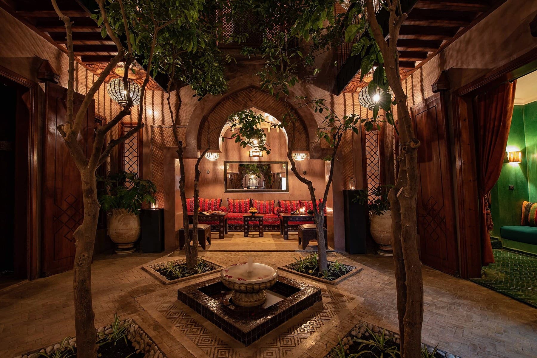Marrakech riad courtyard with trees and traditional details